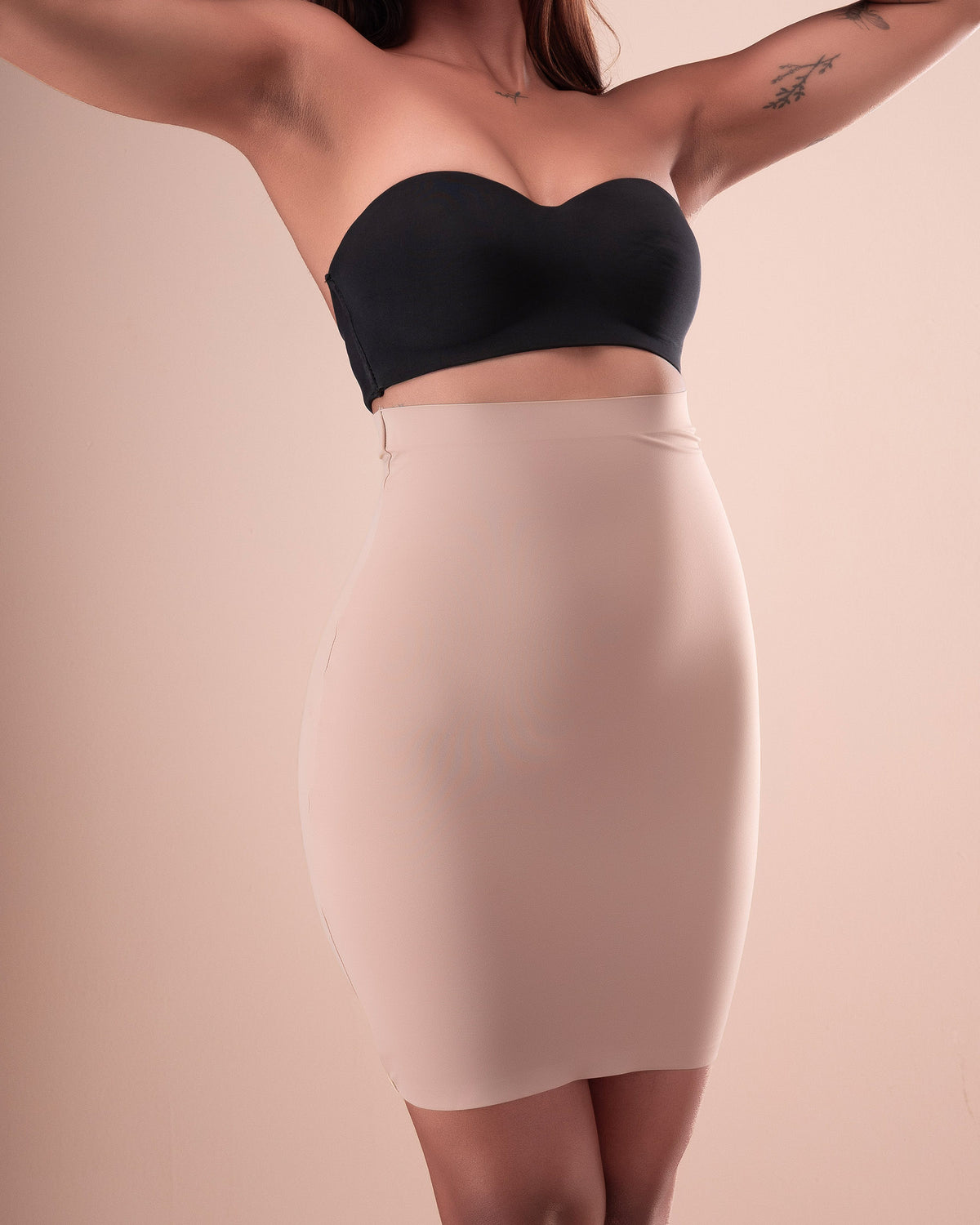 Nude high-waisted shapewear skirt shown from the front.