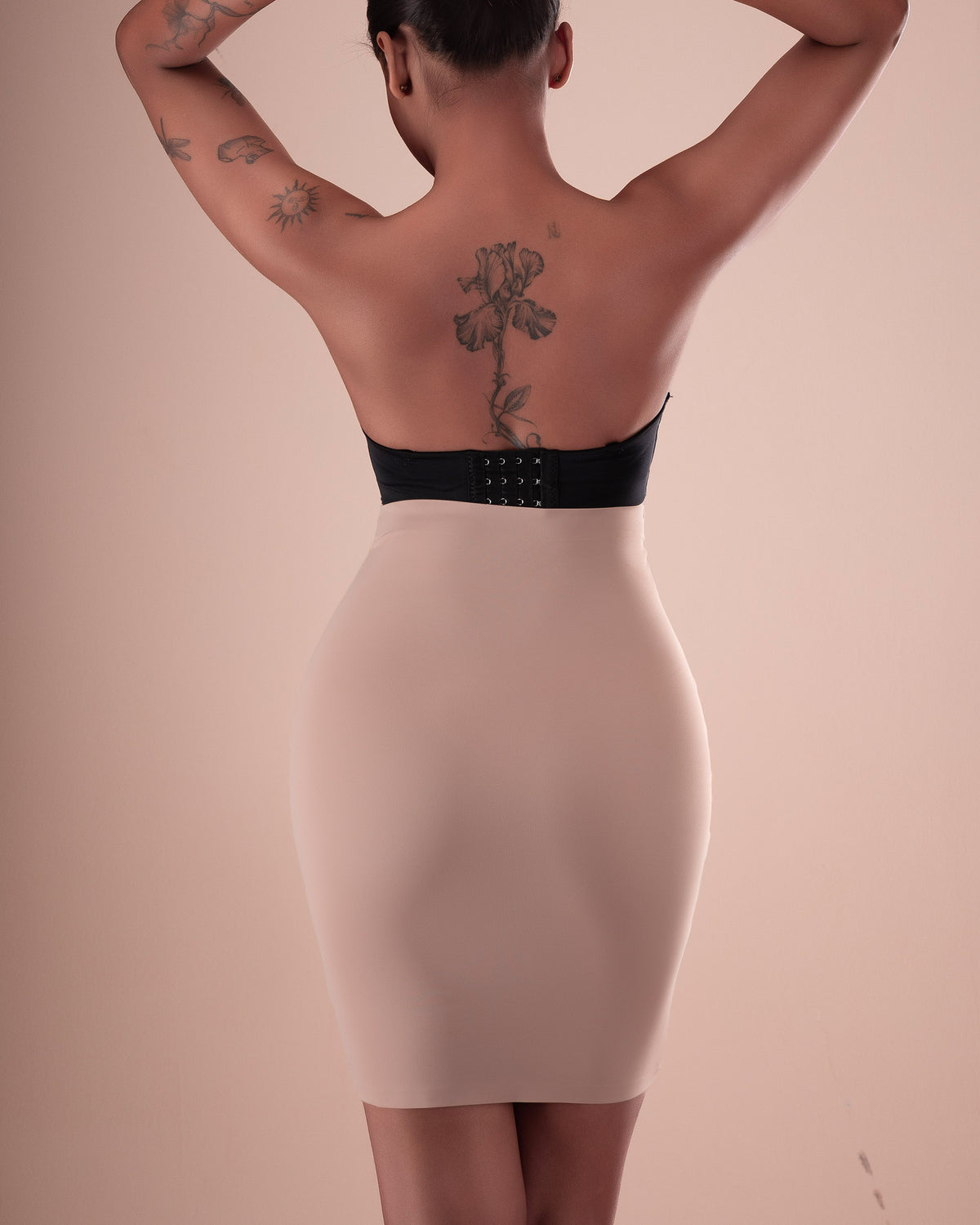 Nude high-waisted shapewear skirt shown from the back.